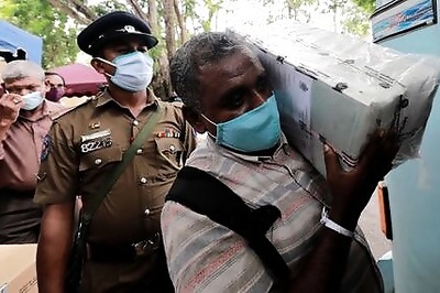 Sri Lankans, wearing masks, flock to voting centres for parliament election