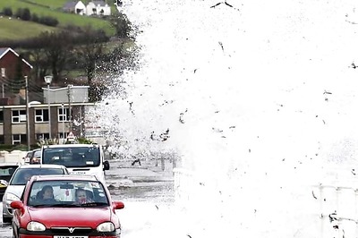 High winds, waves and tides lash Britain's coast