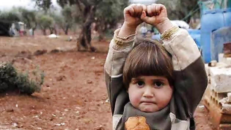 Sad and shocking: Syrian child mistakes camera for a gun, holds her hand up in surrender