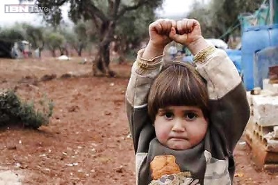 Sad and shocking: Syrian child mistakes camera for a gun, holds her hand up in surrender