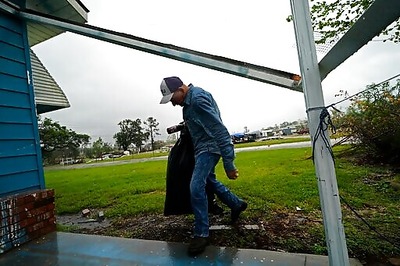 The Latest: Delta Downgraded But Still Causing Damage