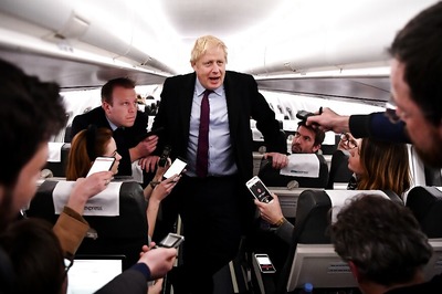 Boris Johnson Pockets Reporter's Phone after He Shows Him Photo of Sick Boy Lying on Pile of Coats